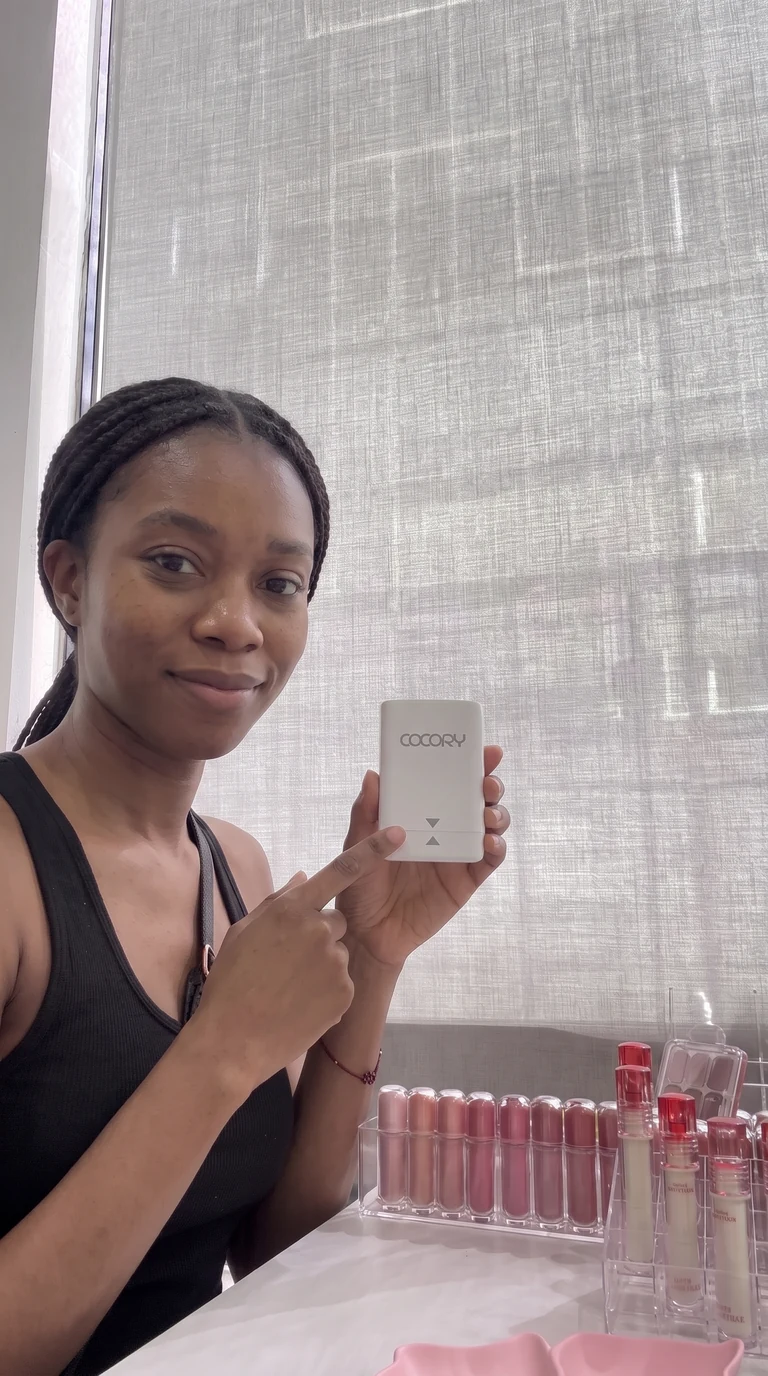 Client displaying customized skin tone cosmetic calibration results at COCORY New York studio in Midtown Manhattan